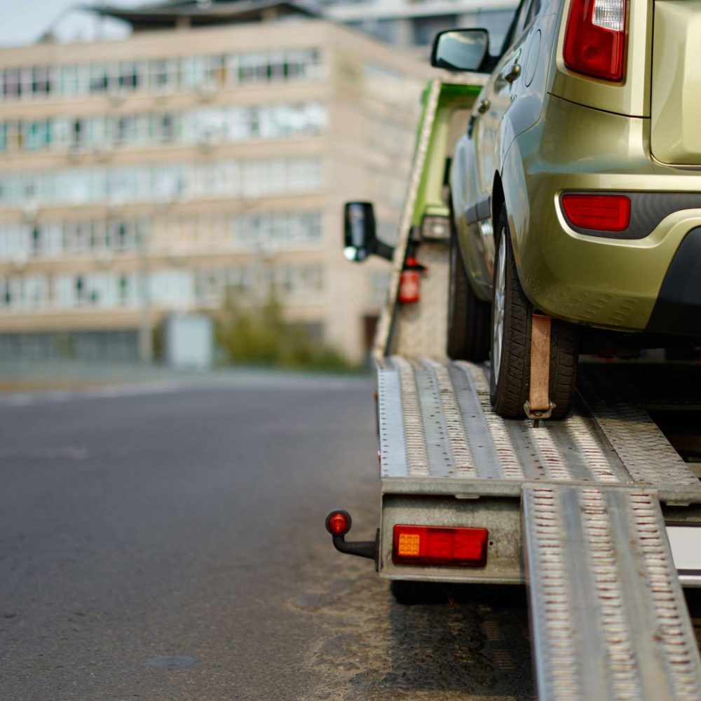 car-being-towed-on-a-flatbed-trailer-2026-03-13-04-24-48-utc (1)